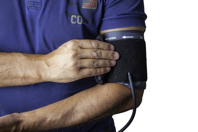 Healthcare worker applying blood pressure monitor